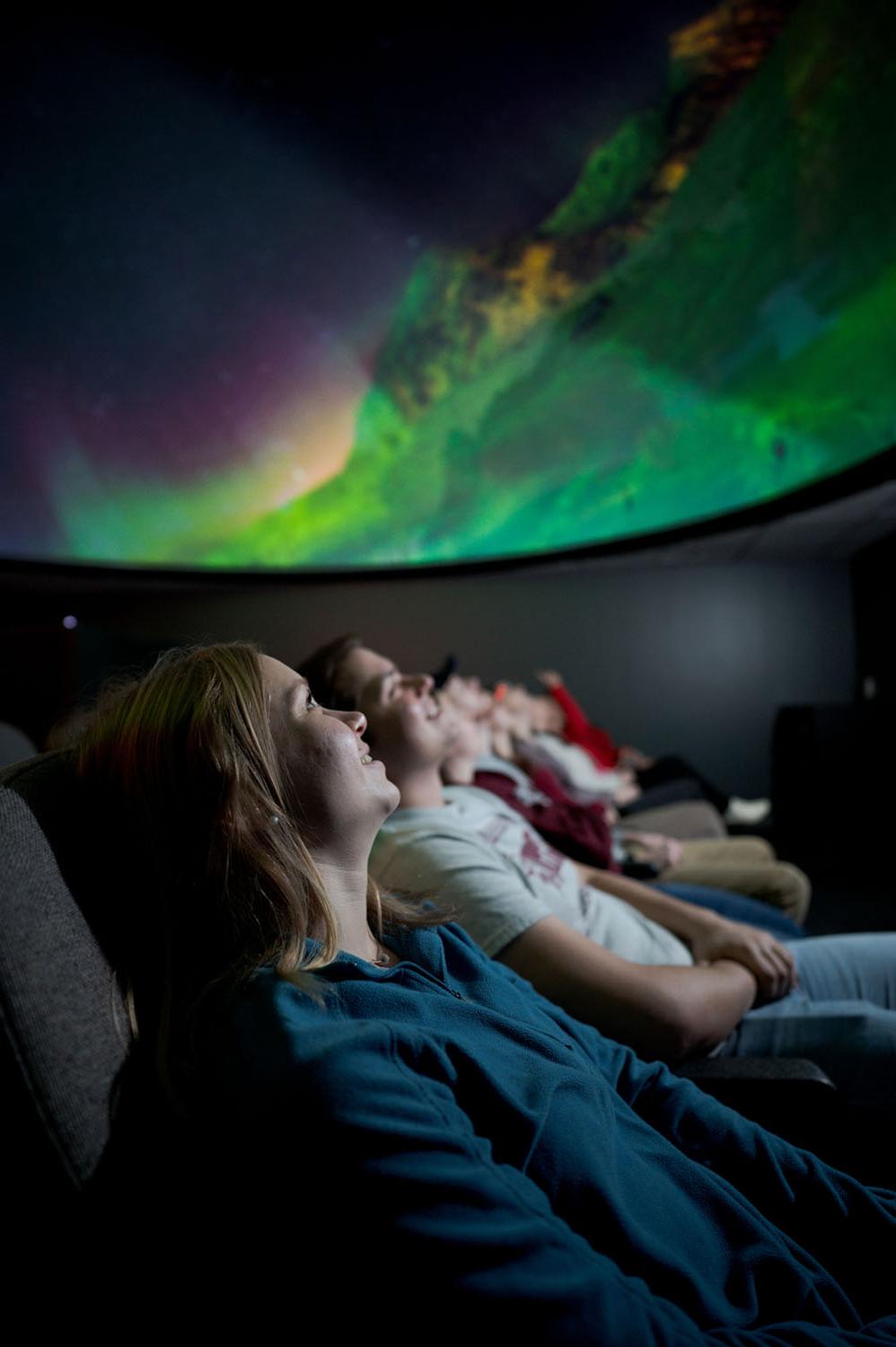 Students watch a show in the planetarium